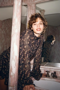 Close-up of floral chiffon dress detail with ruffled cuffs and retro stand collar