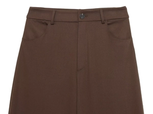 Detailed close-up of dark brown high-waisted trousers with button and pockets