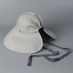 Detail of grey straw sun hat featuring a rear split, ribbon bow, and silver metal logo