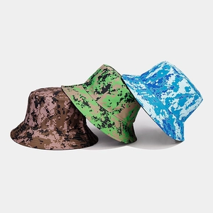 Close-up of three pixel camouflage bucket hats in brown, green, and blue patterns