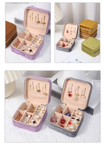 Detail of velvet jewelry boxes in various colors with zippers and necklace hooks