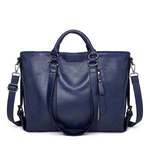 Detail of blue pebbled leather tote bag with silver zipper and detachable shoulder strap