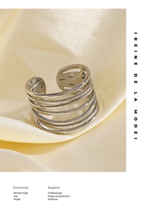 Macro detail of silver multilayer ring featuring handmade hammered texture on silk