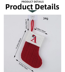 Detail view of red knitted Christmas stocking with white plush cuff and letter A embroidery