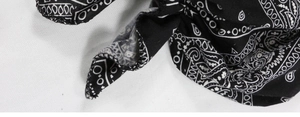 Detail of black paisley pre-tied turban showing elastic stitching and cotton blend fabric