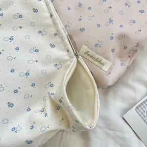 Close-up of floral makeup bags showing premium fabric texture and smooth zipper detail