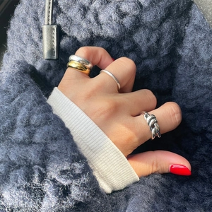 Minimalist 925 sterling silver geometric knot ring set worn on model hand in close-up