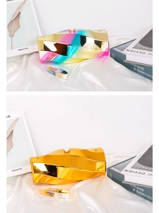 Detailed view of irregular geometric clutch bags in iridescent and gold mirror finishes