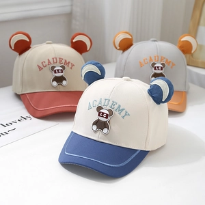 Detail of toddler baseball caps featuring plush bear ears and Academy embroidery in three colors