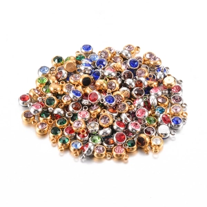 Mixed set of 6mm stainless steel birthstone charms with colorful rhinestones on white background
