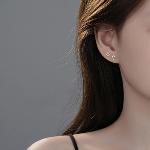 Elegant S925 silver star stud earrings with blue gemstones shown on a model