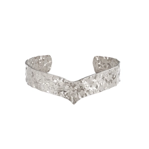 Detailed macro shot of a silver titanium steel open bangle with hammered texture and V-shape
