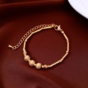 Close-up of 18K gold plated bamboo link bracelet with zircon beads on silk