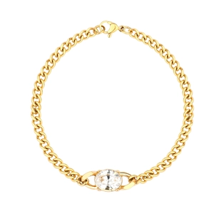Detail of gold Cuban link chain with oval crystal stone and lobster clasp closure