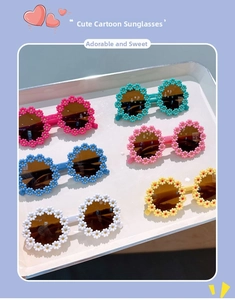Collection of kids flower shaped sunglasses in six colors displayed on white tray