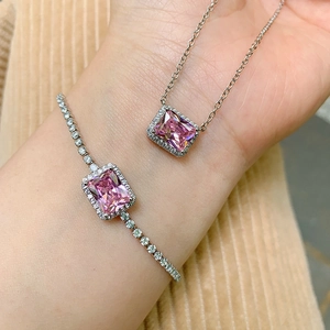 Detail of pink rectangular gemstone jewelry set with necklace and tennis bracelet