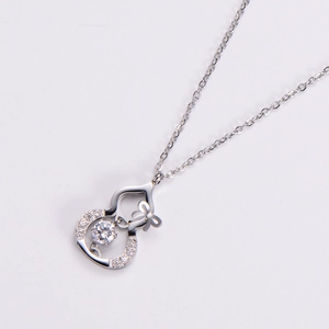Close-up of silver titanium steel wulu pendant with shimmering cubic zirconia stones
