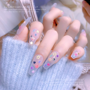 Detail of pink jelly coffin press-on nails with colorful laser star and moon sequins