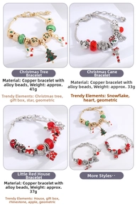 Detail view of colorful Christmas charms and snowflakes on a DIY beaded snake chain bracelet