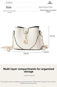 Detailed view of white bucket bag with vertical texture and fish metal pendant