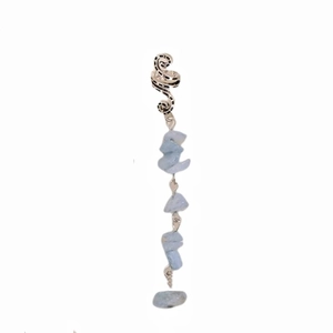 Detailed shot of silver snake-shaped hair charm with irregular blue crystal gemstones