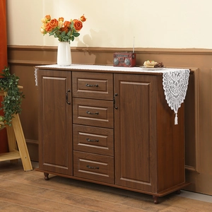 Classic American lace table runner with tassels on a rustic brown wooden sideboard