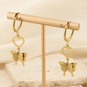 Detail of 18K gold-plated heart and matte butterfly charms on an elegant earring display