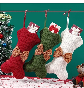 Detailed view of red, green, and white knitted bone-shaped Christmas stockings with bows