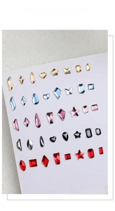 Mix of mini aurora crystal nail art rhinestones in various shapes like stars and hearts