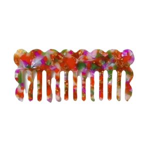 Colorful floral acetate hair comb with marble wave pattern on white background
