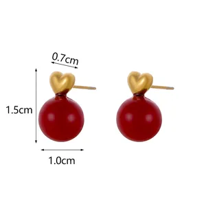 Detailed view of heart-shaped earrings with size dimensions and red round pendant