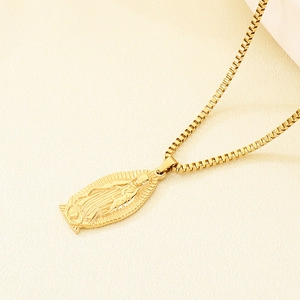 Detail of gold box chain and embossed Virgin of Guadalupe pendant in stainless steel