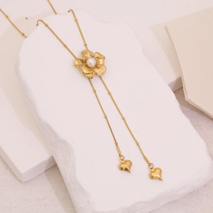 Elegant gold camellia pendant necklace with pearl center and hanging heart tassels