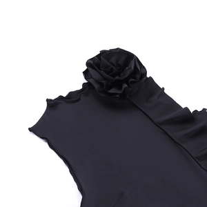 Detail of a black top featuring a large 3D floral decoration and wavy neckline texture