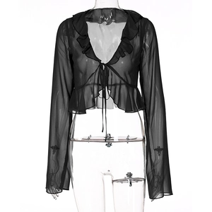 Macro detail of sheer black mesh fabric with ruffle edges and front tie closure