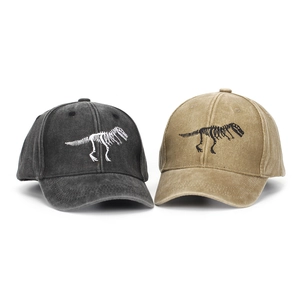 Detail of dinosaur skeleton embroidery on washed vintage cotton baseball caps