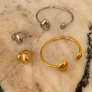 Minimalist 18k gold plated stainless steel open rings and bangles on marble