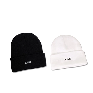 Black and white knitted beanies featuring KING embroidery for winter warmth and style