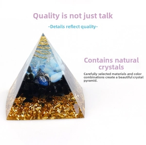 Macro shot of an Orgone pyramid with blue crystals, obsidian, and golden spiral coil
