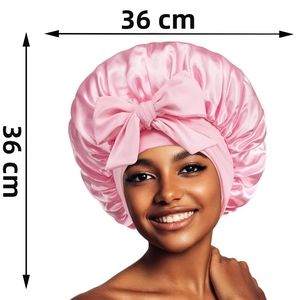 Pink satin sleep cap with large bow detail shown in 36cm dimensions for hair care