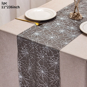 Detail view of Halloween table runner with white spider web pattern on dark grey fabric