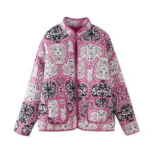 Detailed view of quilted cotton jacket with vintage cat and floral print on white background