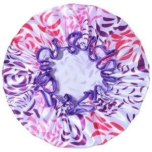 Detail of double-layer satin waterproof shower cap with red leaf print and purple elastic edge