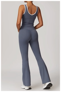 Detail view of the crisscross open back and high-waisted flared yoga pants in blue-grey