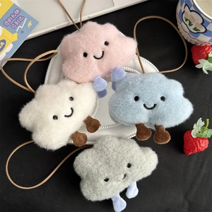 Close-up of colorful plush cloud charms with smiley faces and soft straps for bags