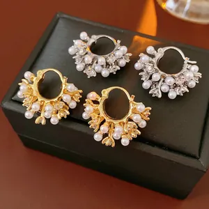 French retro U-shaped pearl hoop earrings with zircon accents on black leather jewelry box
