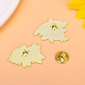 Golden flower-shaped metal pins with secure butterfly clutches and non-slip texture