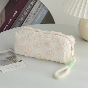 Detail of white sherpa pencil case with 3D heart texture and pink zipper closure