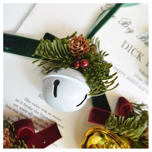 Close-up of velvet bows, pine cones and festive bells on a Christmas hanging ornament