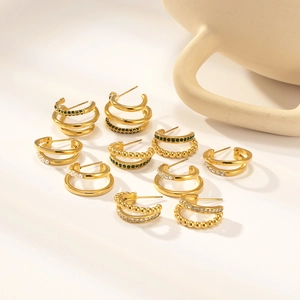 Detailed close-up of 18K gold-plated stainless steel earrings with zircons and small pearls